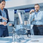 Scientists around a table with robot arm